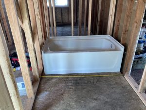Bathtub set in a newly framed bathroom during an addition