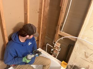Supply lines fitted to a new tub inside open framing